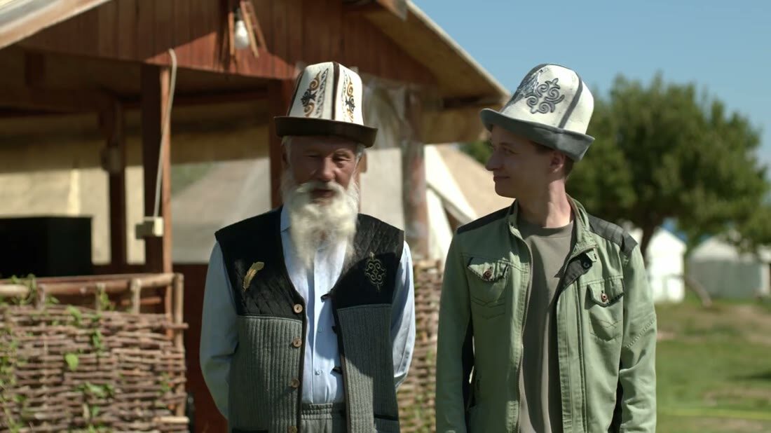 Live-action still — Alex and Bakai in kalpaks